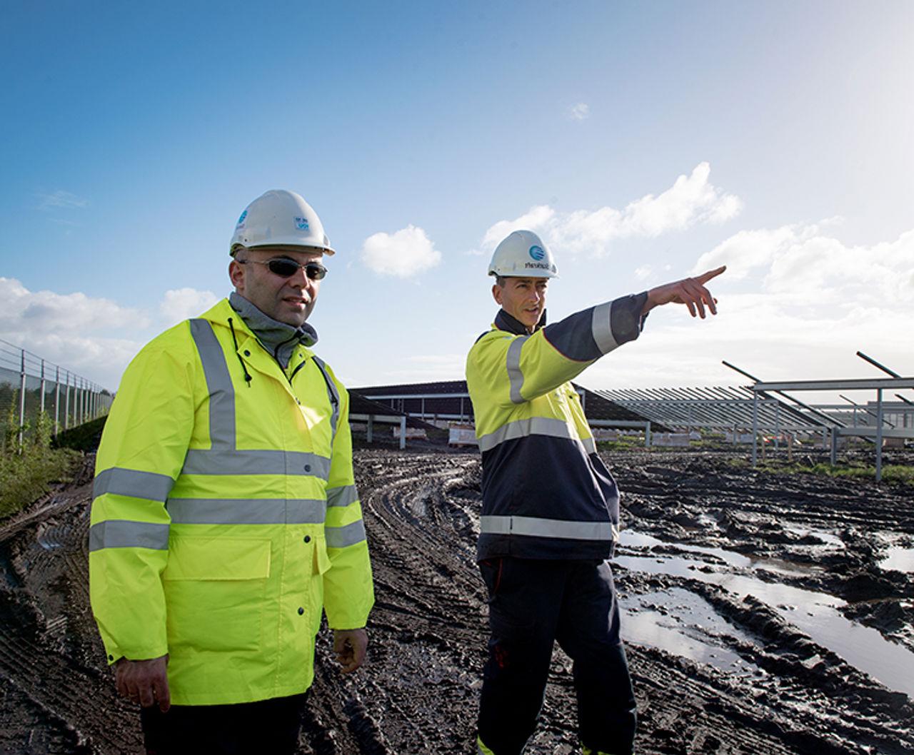 Worker in front of solar plant